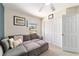Bright bedroom featuring stylish gray sofa, double closets, and a nice window view at 2689 Sw 165Th Street Rd, Ocala, FL 34473