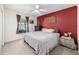 Comfortable bedroom with neutral carpet, window view, and an accent wall at 2689 Sw 165Th Street Rd, Ocala, FL 34473