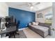 Bright bedroom featuring stylish gray sofa, dark desk, and modern ceiling fan at 2689 Sw 165Th Street Rd, Ocala, FL 34473
