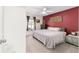 Comfortable bedroom with neutral carpet, window view, and an accent wall at 2689 Sw 165Th Street Rd, Ocala, FL 34473