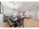 Cozy dining room with seating for six, a decorative chandelier, and seamless access to the living room at 2689 Sw 165Th Street Rd, Ocala, FL 34473