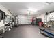 Spacious two car garage converted into a home gym with high ceilings and modern equipment at 2689 Sw 165Th Street Rd, Ocala, FL 34473