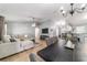 Open-concept living space features a large sectional sofa, dining table, and kitchen bar at 2689 Sw 165Th Street Rd, Ocala, FL 34473