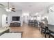 Open-concept living space with wood-look tile floors, kitchen bar, and entertainment center at 2689 Sw 165Th Street Rd, Ocala, FL 34473