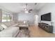 Comfortable living room features a sectional sofa, ceiling fan and sliding glass doors at 2689 Sw 165Th Street Rd, Ocala, FL 34473