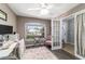 Bright home office featuring a view of the front yard, gray wood floors, and double door entry at 2689 Sw 165Th Street Rd, Ocala, FL 34473