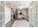 Well-decorated and spacious home office with gray wood floors, white walls, and double door entry at 2689 Sw 165Th Street Rd, Ocala, FL 34473