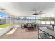 Beautiful screened-in patio with ceiling fans, outdoor seating, a pool table, and dining set at 2689 Sw 165Th Street Rd, Ocala, FL 34473