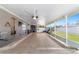 Beautiful screened-in patio with ceiling fans, outdoor seating, a pool table, and tv at 2689 Sw 165Th Street Rd, Ocala, FL 34473