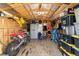 The interior of the shed has a motorcycle, shelves, storage bins, and gear, maximizing available space at 2689 Sw 165Th Street Rd, Ocala, FL 34473