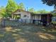 Backyard with a covered parking area, storage, and a partially fenced yard at 2818 Ne 25Th Ct, Ocala, FL 34470