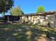 Backyard featuring a lawn, trees, the back of the house, and a screened-in porch at 2818 Ne 25Th Ct, Ocala, FL 34470