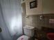 Bathroom featuring a tiled wall with vanity and toilet at 2818 Ne 25Th Ct, Ocala, FL 34470