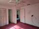 Bedroom featuring two doors and plush carpeting with a ceiling fan at 2818 Ne 25Th Ct, Ocala, FL 34470