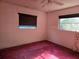 Bedroom featuring two windows and plush carpeting with a ceiling fan at 2818 Ne 25Th Ct, Ocala, FL 34470