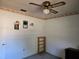 Empty bedroom featuring rose themed wall border with a ceiling fan and empty shelving unit at 2818 Ne 25Th Ct, Ocala, FL 34470