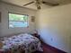 Bedroom featuring floral themed bedding, ceiling fan and a view from the window at 2818 Ne 25Th Ct, Ocala, FL 34470