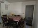 Dining area with a table set for six and simple tile flooring at 2818 Ne 25Th Ct, Ocala, FL 34470