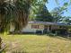 Modest single story house with a lawn and mature trees in a natural setting at 2818 Ne 25Th Ct, Ocala, FL 34470