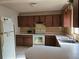 Kitchen features basic appliances, wood cabinets, and a compact eat-in dining area at 2818 Ne 25Th Ct, Ocala, FL 34470