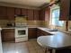 Kitchen with wood cabinets, basic appliances, and retro countertops at 2818 Ne 25Th Ct, Ocala, FL 34470