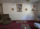 Neutral living room featuring red carpet, old decor, and a simple layout at 2818 Ne 25Th Ct, Ocala, FL 34470
