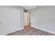 Bright bedroom features a closet with panel doors and sleek, modern flooring at 3 Redwood Track Run, Ocala, FL 34472