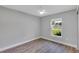 Empty bedroom featuring laminate flooring and a window view at 3 Redwood Track Run, Ocala, FL 34472