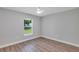 Empty bedroom featuring laminate flooring and a window view at 3 Redwood Track Run, Ocala, FL 34472