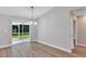 Open dining area with sliding glass doors to the backyard, complemented by stylish lighting at 3 Redwood Track Run, Ocala, FL 34472