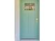 Stylish front door with geometric window offers a pop of color and curb appeal at 3 Redwood Track Run, Ocala, FL 34472