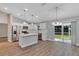 Modern kitchen featuring white cabinets, stainless steel appliances, and a stylish island with pendant lighting at 3 Redwood Track Run, Ocala, FL 34472
