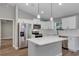 Modern kitchen with white cabinetry, stainless steel appliances, and a functional island perfect for entertaining at 3 Redwood Track Run, Ocala, FL 34472