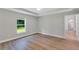 Bright main bedroom featuring luxury floors, a window, and trim at 3 Redwood Track Run, Ocala, FL 34472