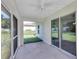Covered patio with ceiling fan offers seamless indoor-outdoor living and relaxation at 3 Redwood Track Run, Ocala, FL 34472