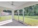 Screened in patio with ceiling fan overlooking a lush and manicured backyard at 3 Redwood Track Run, Ocala, FL 34472