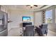Open living room with kitchen and seating area with television and backyard views at 3053 Canopy Oak Blvd, Wildwood, FL 34785