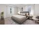 Serene bedroom with tray ceiling, plush carpet, and ample natural light at 3059 Canopy Oak Blvd, Wildwood, FL 34785