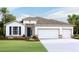 Charming single-Gathering home boasting a three-car garage and lush landscaping at 3059 Canopy Oak Blvd, Wildwood, FL 34785