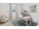 Bright home office featuring a desk, shelving, and a comfortable chair at 3059 Canopy Oak Blvd, Wildwood, FL 34785