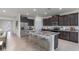 Spacious kitchen island with seating, granite countertops, and stainless-steel appliances at 3059 Canopy Oak Blvd, Wildwood, FL 34785