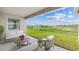 Enjoy the scenic backyard view from the covered patio with comfortable seating at 3059 Canopy Oak Blvd, Wildwood, FL 34785