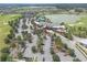 This aerial shows an expansive parking lot, clubhouse, and lake in a vibrant residential golf community at 3918 Nw 46Th Ter, Ocala, FL 34482