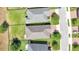 Aerial view of rooftops of houses, well-manicured lawns, trees, and nearby streets at 3918 Nw 46Th Ter, Ocala, FL 34482