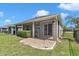 A covered lanai overlooks the beautiful backyard with brick paver patio at 3918 Nw 46Th Ter, Ocala, FL 34482
