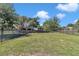 Wide view of the large backyard with mature trees and a black metal fence at 3918 Nw 46Th Ter, Ocala, FL 34482