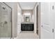Bathroom featuring a glass shower door, black vanity, and access to a walk-in closet at 3918 Nw 46Th Ter, Ocala, FL 34482