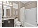 Cozy bathroom features a granite vanity top and shower-tub combination at 3918 Nw 46Th Ter, Ocala, FL 34482
