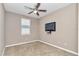 Bright bedroom featuring a ceiling fan, a window for natural light, and a mounted television at 3918 Nw 46Th Ter, Ocala, FL 34482
