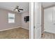 Cozy bedroom with neutral walls, ceiling fan, and a mounted TV for relaxed entertainment at 3918 Nw 46Th Ter, Ocala, FL 34482